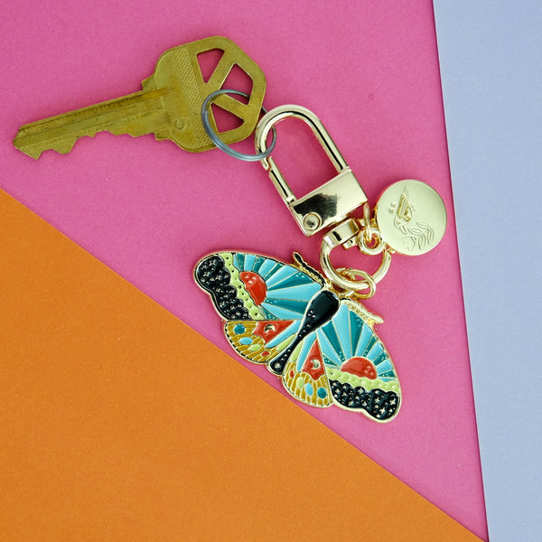 611fc05e3c4ce80992caae23_cosmicmoth-enamelkeychain-inuse-01_1790897078433.jpg